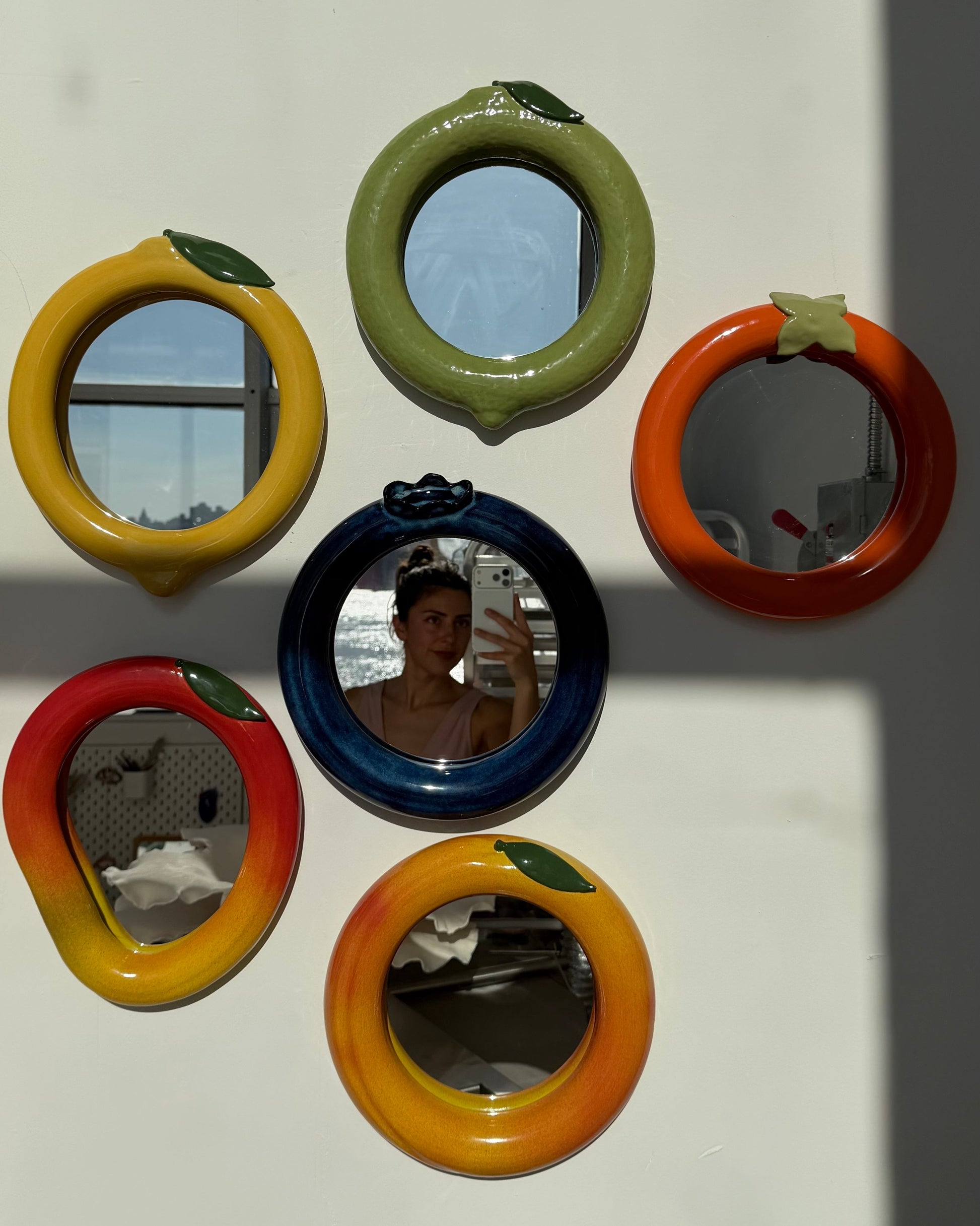 Set of colorful round mirrors on a white background