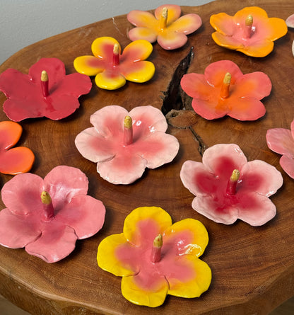 colorful hibiscus ring holders in pinks yellow orange and red
