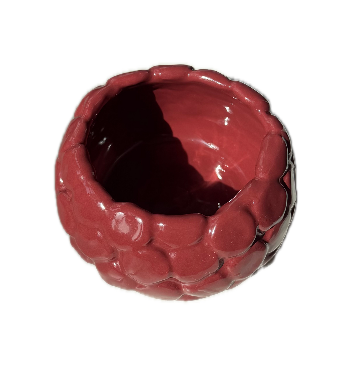 A glossy, raspberry shaped, textured ceramic bowl in a deep reddish-brown color, shown from a top-down perspective on a plain white background.