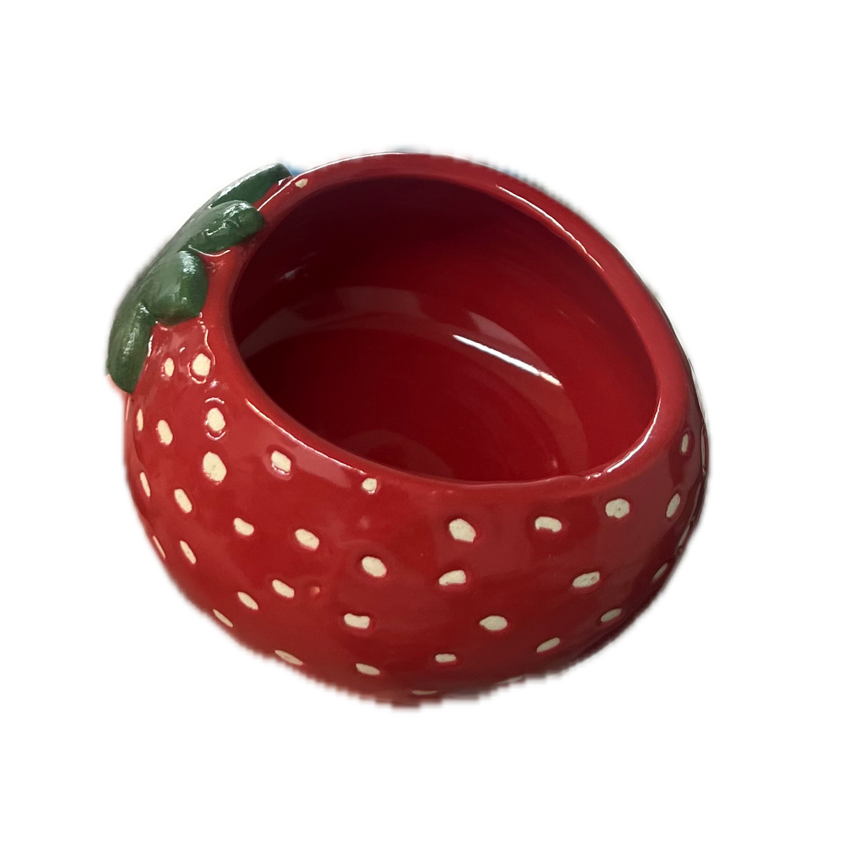 A red strawberry-shaped cup with white polka dots and a green leaf detail on the side, shown against a plain white background.