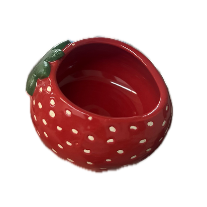 A red strawberry-shaped cup with white polka dots and a green leaf detail on the side, shown against a plain white background.